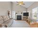 Living room with a fireplace, vaulted ceiling, and large windows at 516 Gumview Cir, Fuquay Varina, NC 27526