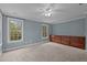 Blue bedroom with two windows, ceiling fan, and dresser at 5600 Thornburg Dr, Wake Forest, NC 27587