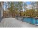 Grey deck with pergola overlooking inground pool and wooded area at 5600 Thornburg Dr, Wake Forest, NC 27587