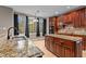 Kitchen features granite countertops, double sinks, and dark wood cabinets at 5600 Thornburg Dr, Wake Forest, NC 27587