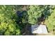 Aerial view of a house near a pond, surrounded by trees at 7100 Lake Myra Rd, Wendell, NC 27591