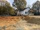 New construction home with front porch and deck, partially landscaped yard at 715 Ross St, Burlington, NC 27217