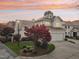 Two-story home with white exterior, dark roof, and landscaping at 739 Crabtree Crossing Pkwy, Cary, NC 27513