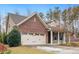 Brick and taupe two-story house with a two-car garage and American flag at 804 Alligator Lake Ct, Fuquay Varina, NC 27526