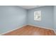 Spacious bedroom with light walls and wood floors at 821 Shari Ct, Durham, NC 27704