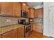 Well-equipped kitchen with granite counters and wood cabinets at 8329 Niayah Way, Raleigh, NC 27612