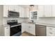 Stylish kitchen with white shaker cabinets and granite counters at 104 Lippizanner Pl, Zebulon, NC 27597