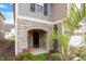 Front entrance with stone archway, black door, and lush landscaping at 135 Station Dr, Morrisville, NC 27560