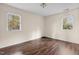 Spacious bedroom with dark brown laminate wood flooring and two windows at 148 Silver Lake Pt Pt, Sanford, NC 27332