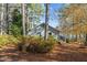 Lakefront home nestled among tall trees in the fall at 148 Silver Lake Pt Pt, Sanford, NC 27332