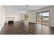 Gathering room with dark brown laminate wood flooring and sliding glass doors to a lake view at 148 Silver Lake Pt Pt, Sanford, NC 27332