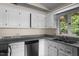 Bright kitchen features white cabinets, granite countertops, and stainless steel appliances at 148 Silver Lake Pt Pt, Sanford, NC 27332