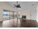 Living room with fireplace, hardwood floors, and sliding glass doors leading to a deck with water views at 148 Silver Lake Pt Pt, Sanford, NC 27332