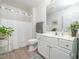 Clean bathroom with a shower/tub combo, white vanity, and a large mirror at 1512 Meadston Dr, Durham, NC 27712