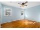 Bright bedroom with hardwood floors and ceiling fan at 1605 Spring Dr, Garner, NC 27529