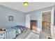 Light blue-walled bedroom with twin bed, dresser, and view of upper hallway at 1706 Lisburn Ct, Garner, NC 27529