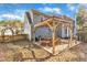 Patio area with wooden pergola and seating at 1706 Lisburn Ct, Garner, NC 27529