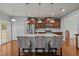 Island kitchen with stainless steel appliances and hardwood floors at 1807 Nellora Ln, Durham, NC 27703