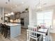 Modern kitchen with gray cabinets, white countertops, and an island with seating at 188 Reese Dr, Willow Springs, NC 27592