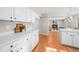 White kitchen cabinets, quartz countertops, and open concept to living room at 203 Hillside Dr, Smithfield, NC 27577