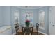 Cozy breakfast nook with glass table and three chairs at 208 Mallard Creek Dr # B, Graham, NC 27253