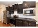 Kitchen boasts stainless steel appliances and dark wood cabinets at 219 Rosedale Creek Dr, Durham, NC 27703