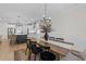 Bright dining room with farmhouse table and chandelier, adjacent to the kitchen at 2913 Violet Way, Fuquay Varina, NC 27526