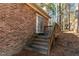Wooden deck and stairs leading to a brick house at 3064 Carolina Way, Sanford, NC 27332