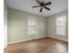Bright bedroom with ceiling fan and laminate wood floors at 3064 Carolina Way, Sanford, NC 27332