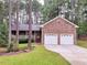 Brick ranch house with two-car garage and landscaped yard at 3064 Carolina Way, Sanford, NC 27332