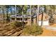 Brick house with two-car garage and porch, nestled among tall pines at 3064 Carolina Way, Sanford, NC 27332