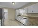 Kitchen boasts granite countertops, white cabinets, and stainless steel appliances at 3064 Carolina Way, Sanford, NC 27332