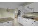 Kitchen with granite countertops, white cabinets, and stainless steel appliances at 3064 Carolina Way, Sanford, NC 27332