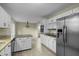 Open kitchen with granite island, white cabinets, and stainless steel appliances at 3064 Carolina Way, Sanford, NC 27332