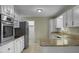 Kitchen with granite countertops, white cabinets, and stainless steel appliances at 3064 Carolina Way, Sanford, NC 27332