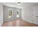 Well-lit bedroom with hardwood floors and double windows at 3128 Gold Dust Ln, Willow Springs, NC 27592