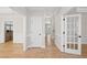 Bright hallway with hardwood floors and white doors at 3128 Gold Dust Ln, Willow Springs, NC 27592