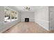 Living Room with hardwood floors, fireplace, and large windows at 3128 Gold Dust Ln, Willow Springs, NC 27592