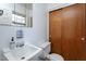 Clean bathroom with white sink and wooden closet at 3210 Courtney Ln, Sanford, NC 27330