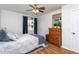 Second bedroom with wooden dresser and blue curtains at 3210 Courtney Ln, Sanford, NC 27330