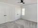 Bright bedroom with gray walls, ceiling fan, gray carpet and double door closet at 3317 E Jameson Rd, Raleigh, NC 27604