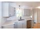 Updated kitchen featuring gray cabinets and quartz countertops at 3317 E Jameson Rd, Raleigh, NC 27604