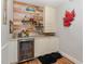 Well-equipped basement bar with beverage fridge, shelving, and decorative accents at 400 Challenge Rd, Raleigh, NC 27603