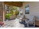 Relaxing covered patio with tiled flooring and comfortable seating at 400 Challenge Rd, Raleigh, NC 27603