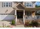 Brick staircase leading to a charming front porch with white railings at 400 Challenge Rd, Raleigh, NC 27603