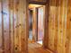 Hallway with wood paneled walls and doors to other rooms at 477 Providence Rd, Roxboro, NC 27574