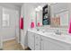 Bathroom with double vanity, white cabinets, and bright pink accents at 50 Timber Ct, Spring Hope, NC 27882