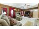 Spacious living room includes a fireplace, wood paneling, and large screen TV at 6010 Scalybark Rd, Durham, NC 27712