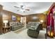 Relaxing living room features wood paneling, a ceiling fan and comfortable seating at 6010 Scalybark Rd, Durham, NC 27712