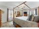 Large main bedroom with a four-poster bed, TV and plenty of natural light at 6010 Scalybark Rd, Durham, NC 27712